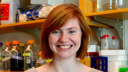 Person with red hair in front of lab bench