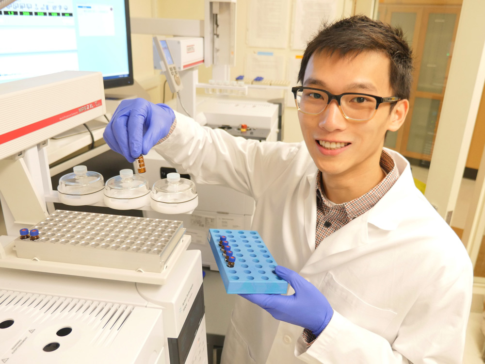 Person at lab instrument with sample