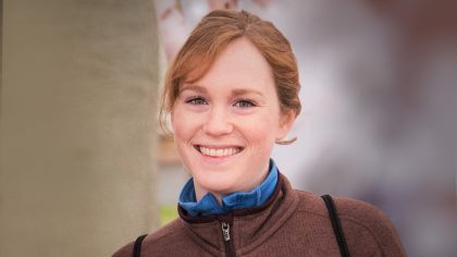 Person smiling with hair in ponytail