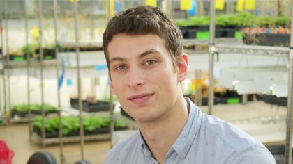 Person in greenhouse smiling