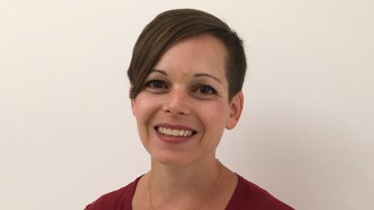 Person with short hair smiling