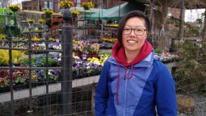 Person smiling by flowers