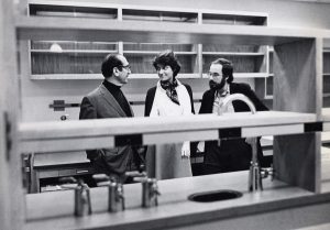 Black and white image of 3 people in lab