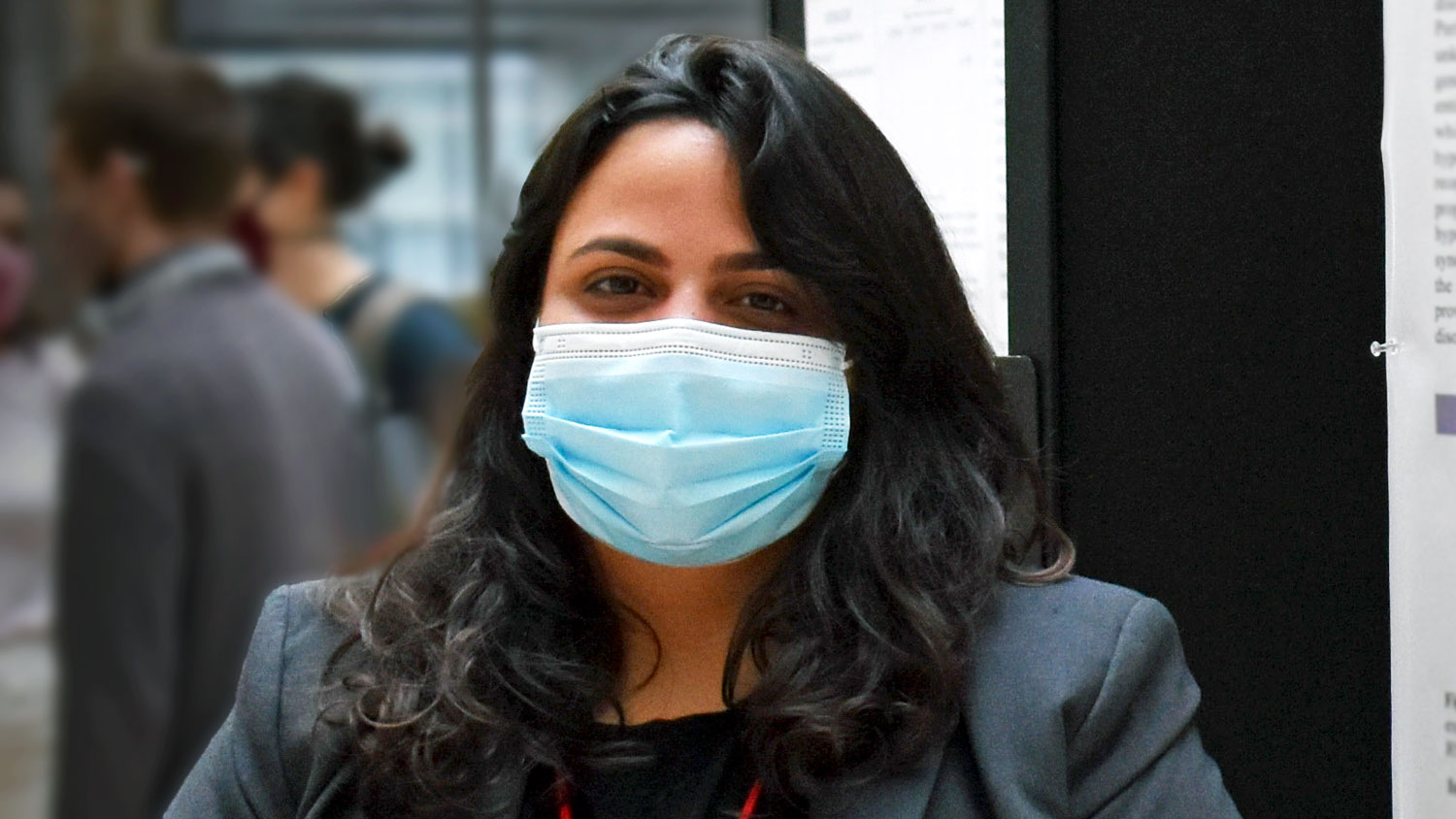 Woman wearing mask at scientific poster session