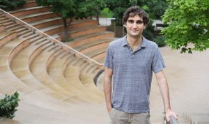 Man smiling outside by stairs