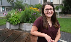 Woman smiling outside on bench